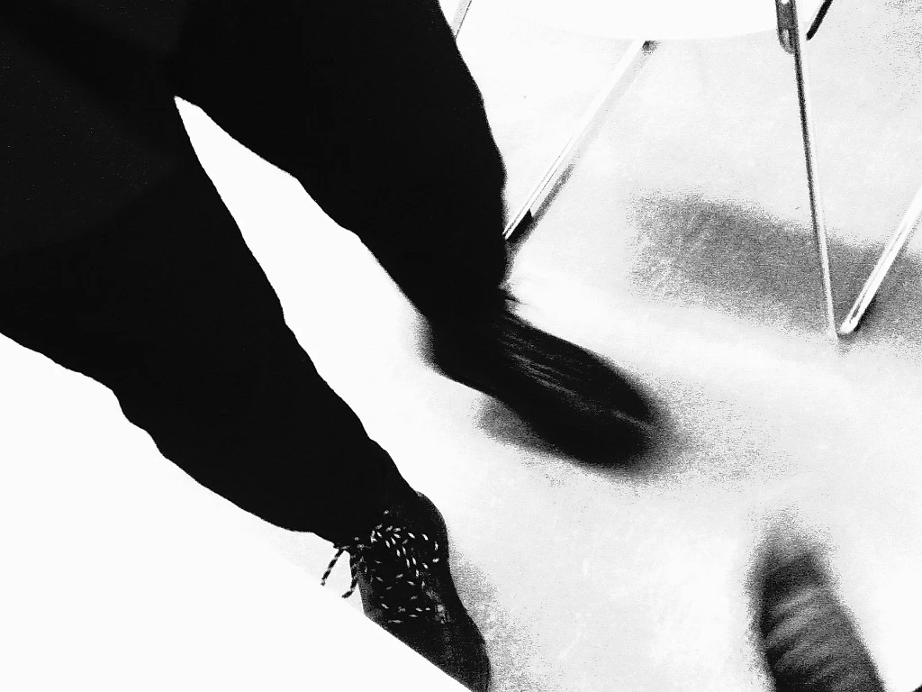Black-and-white study of legs and shadow