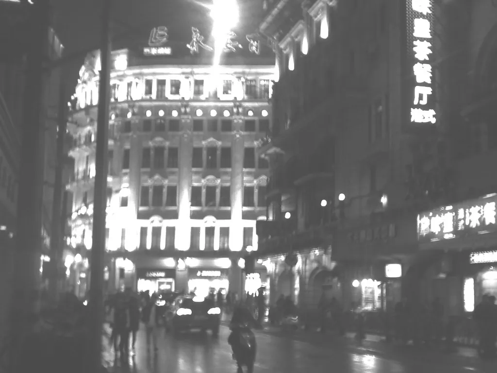 City street at night with illuminated signs